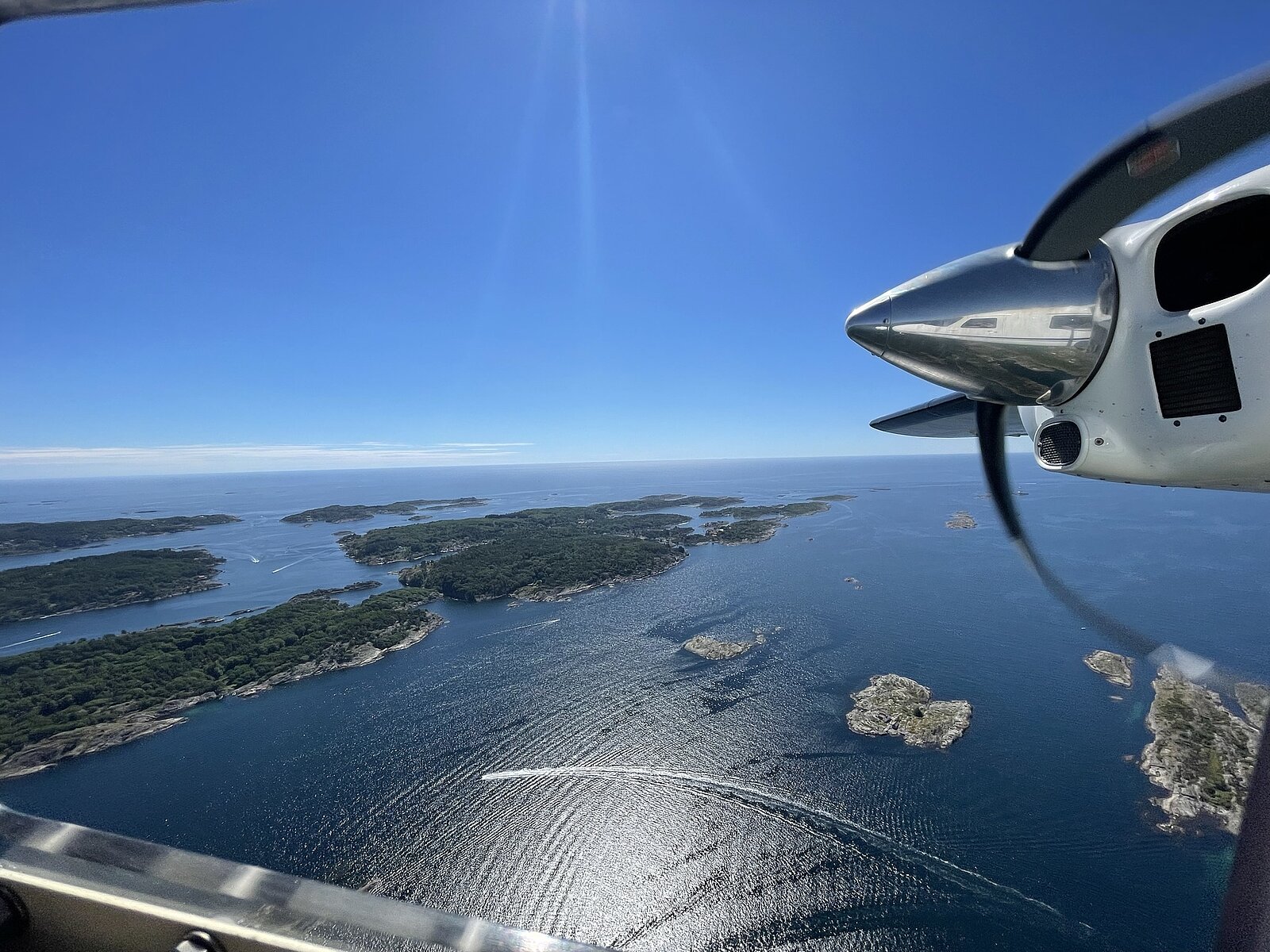 View from a plane over water and forested islands