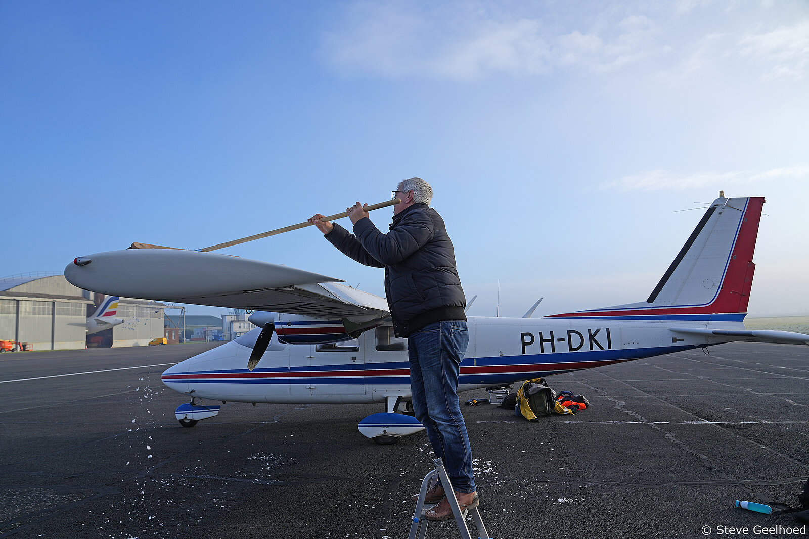 Pilot de-icing the aircraft